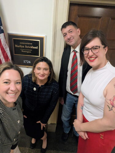 Modern Military's advocacy team, along with Equitas Health, in front of Representative Strickland's office after a meeting for HIV+ service.